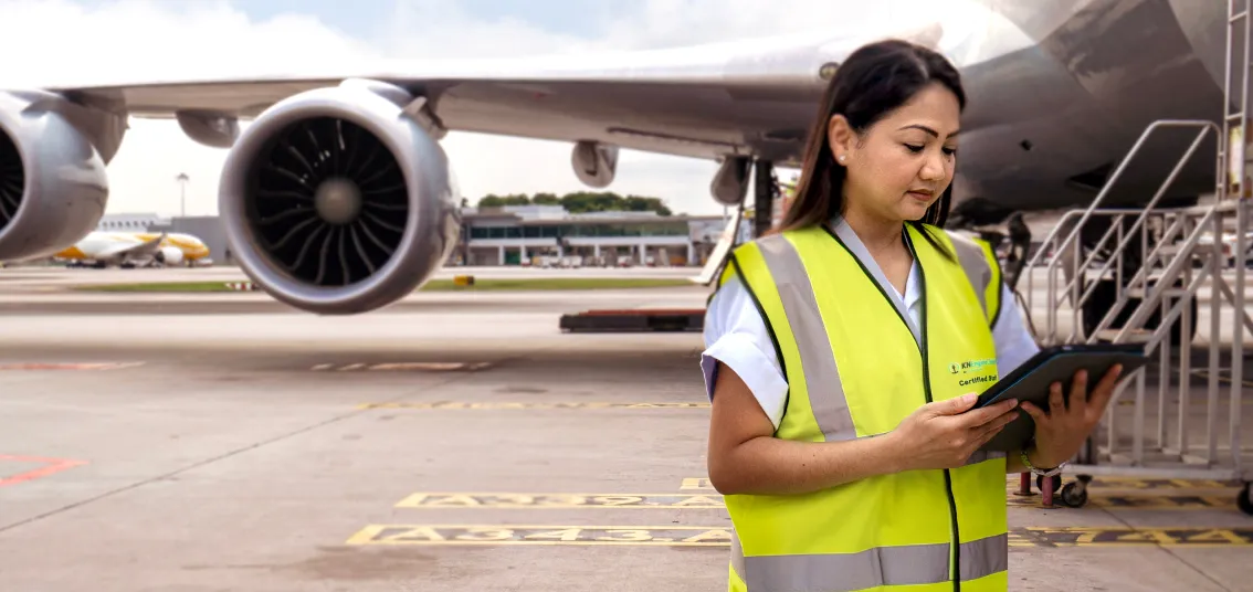 An engine logistics expert doing checks outside a plane