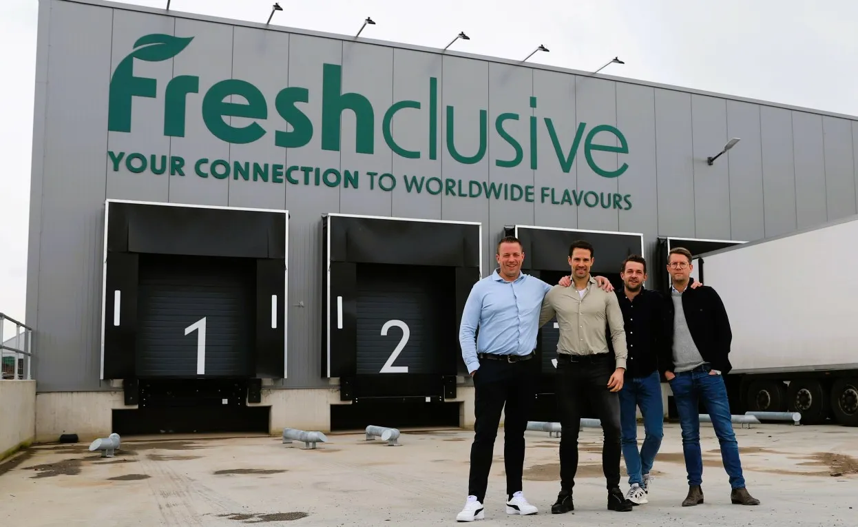 Four men standing in front of a warehouse