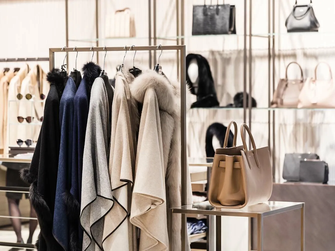 Different types of coats and hand bags in a store