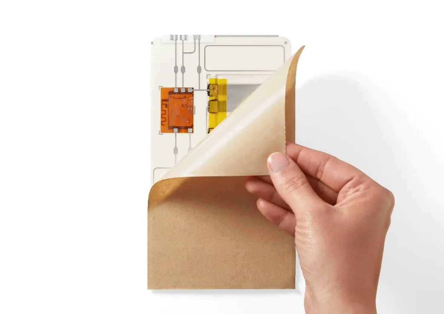 A hand pulling a film from a chip.