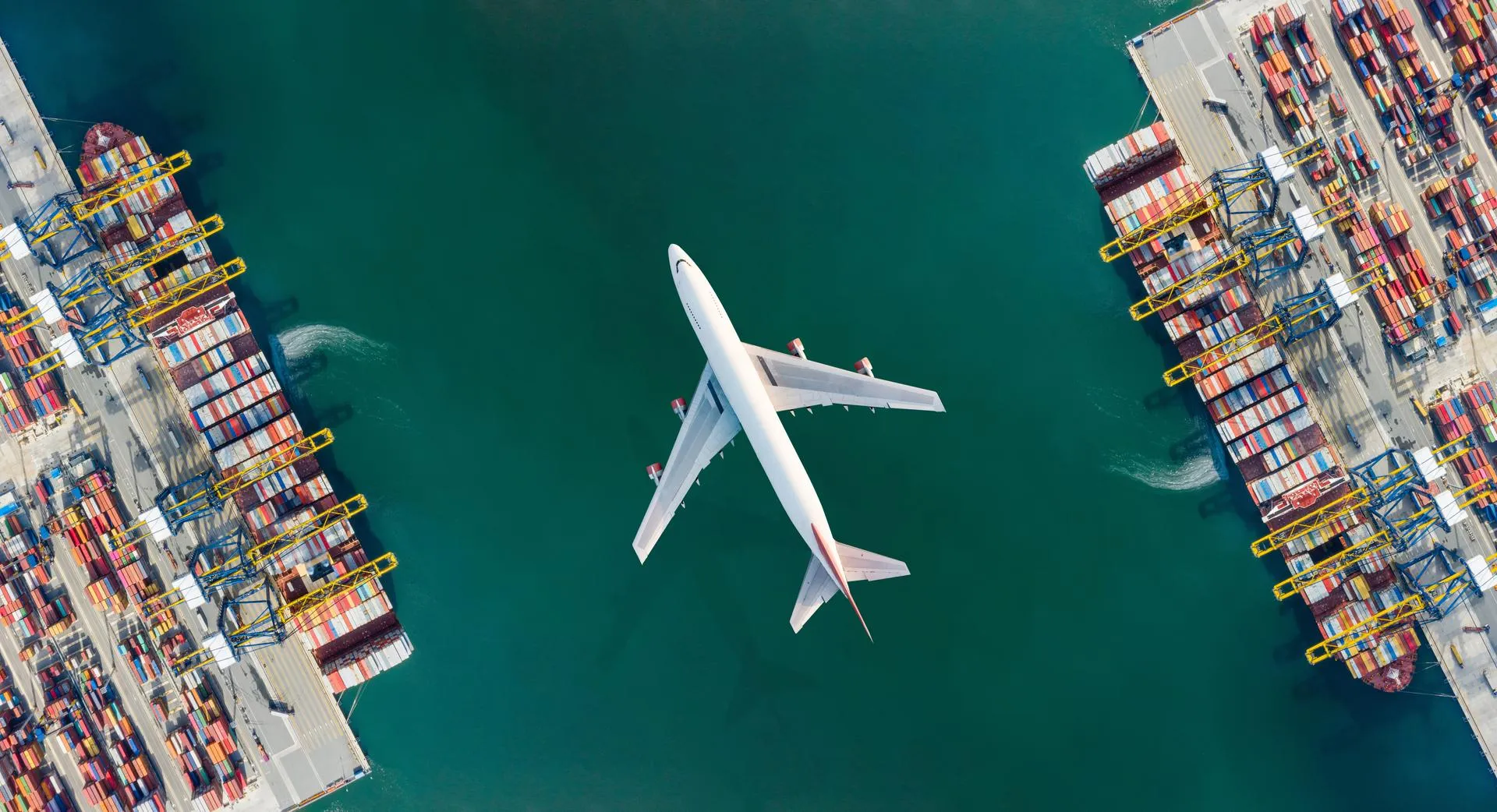 Plane and vessels in a harbour from above