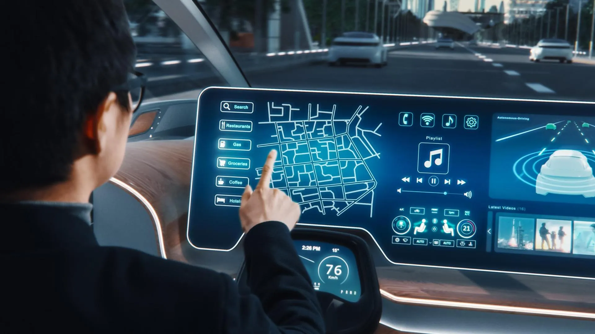 Close-up of a person interacting with a large, futuristic in-car touchscreen, while driving on a multi-lane road.