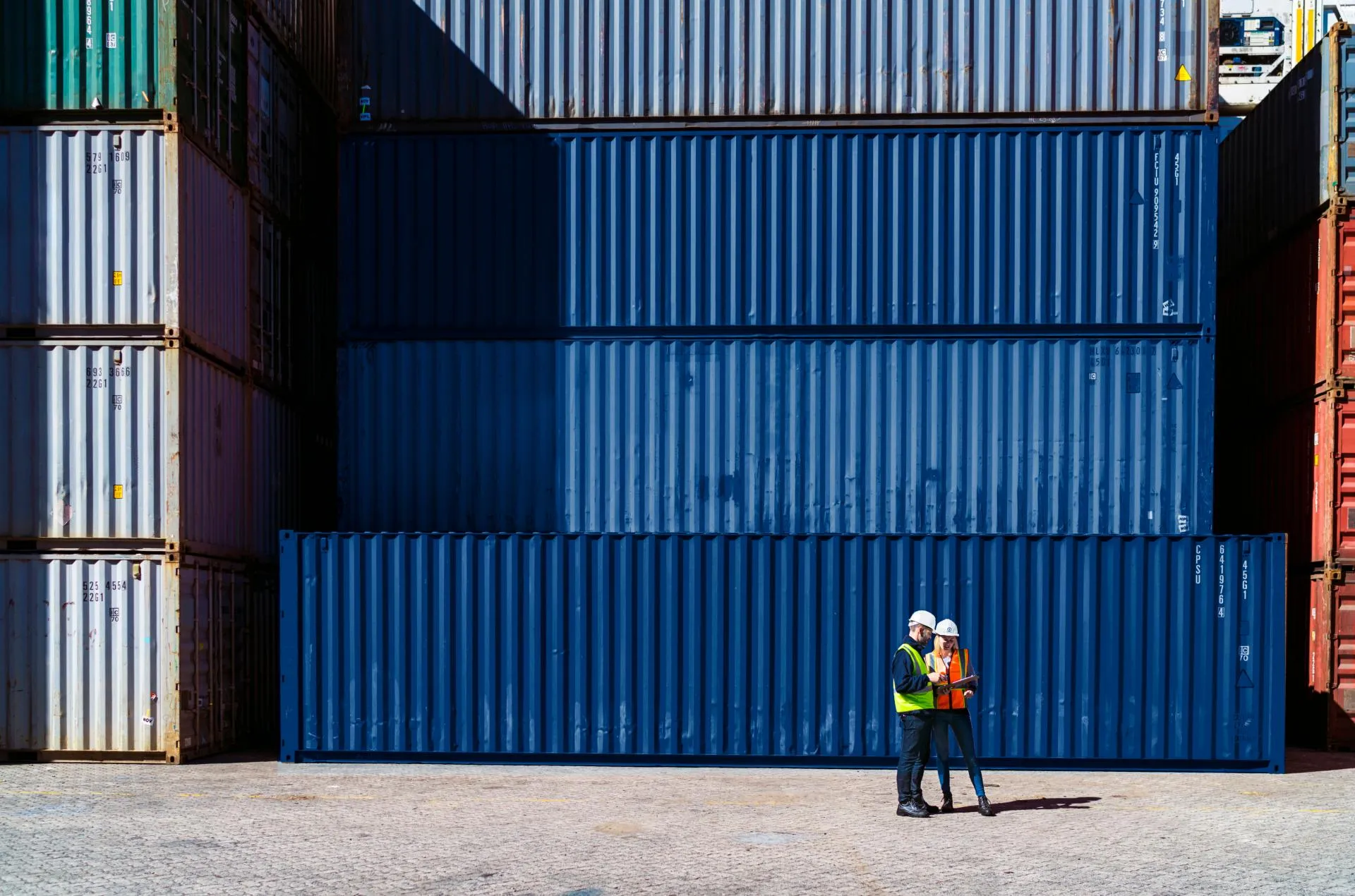 Workers-having-discussion-against-cargo-containers