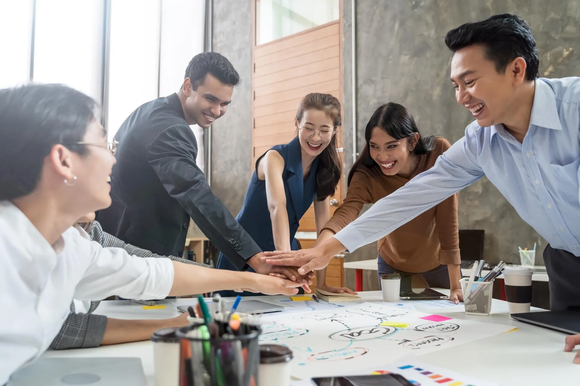 A team of individuals siting in a meeting room