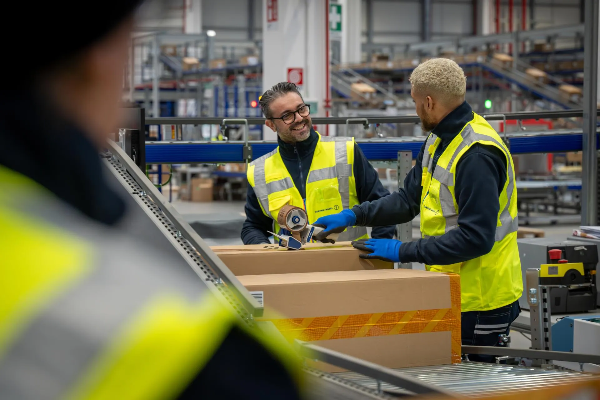 Two men packing boxes at a warehouse.