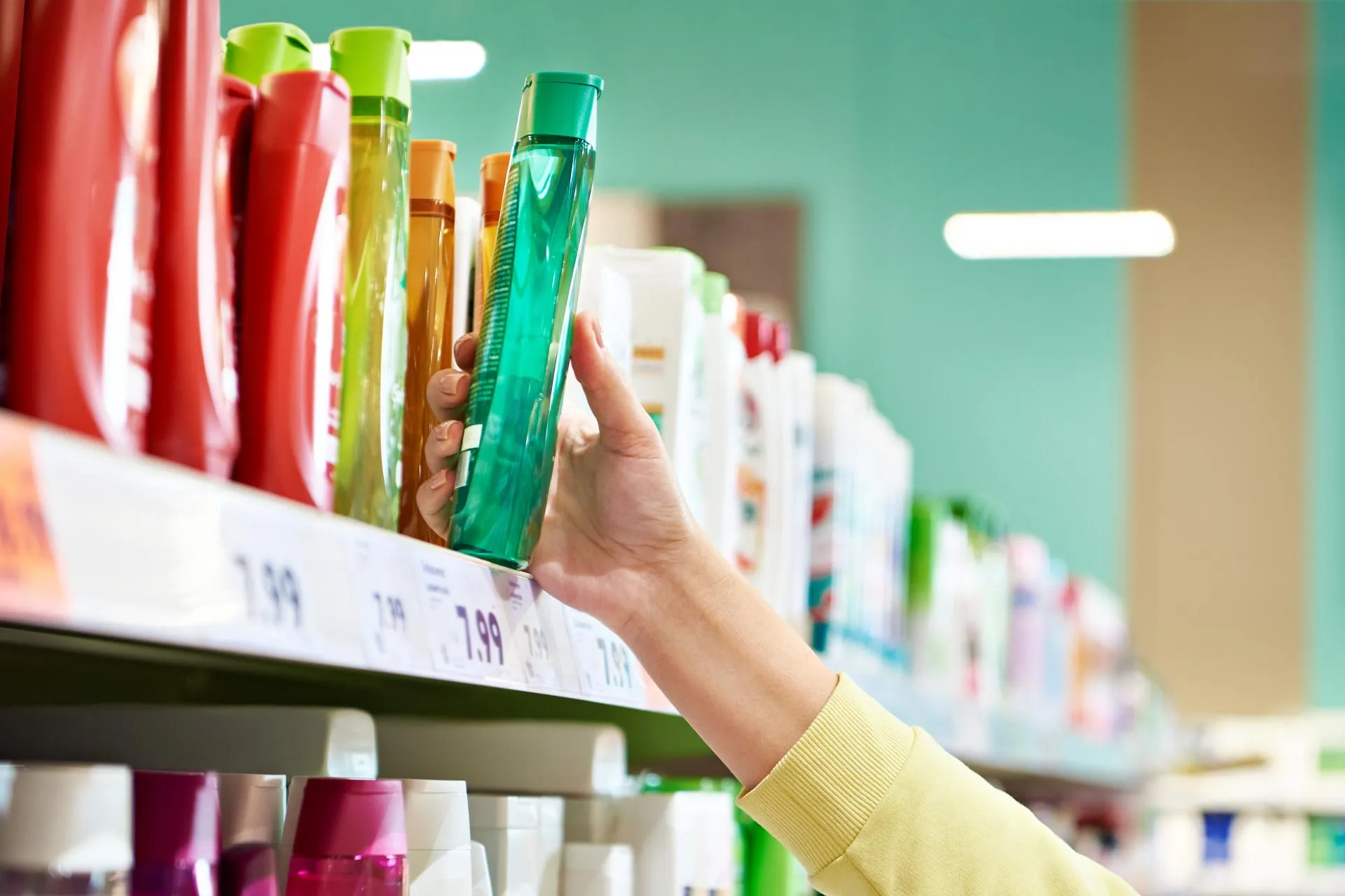 Hend fetches shampoo from a shelf