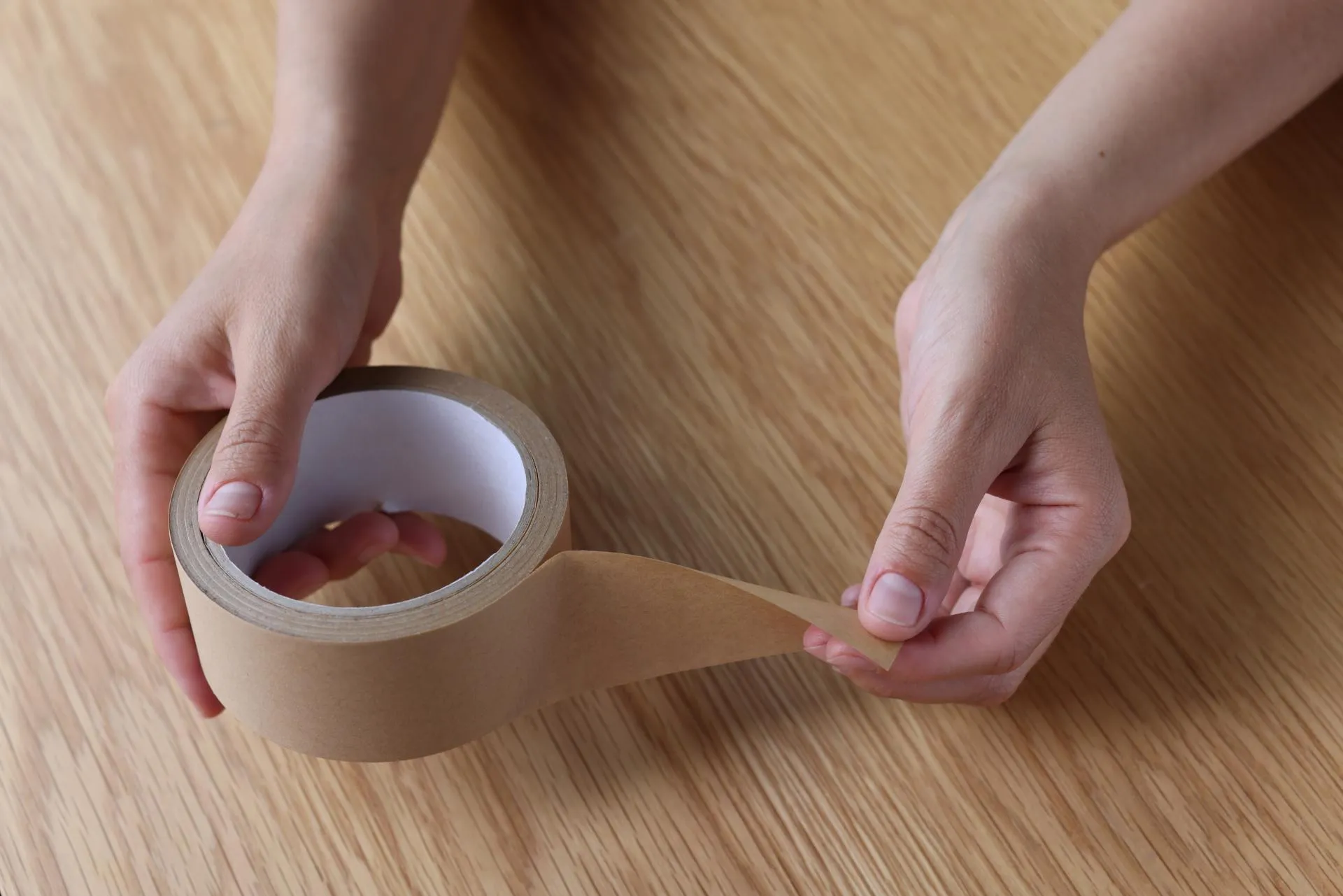 Persons's hands holding a paper tape
