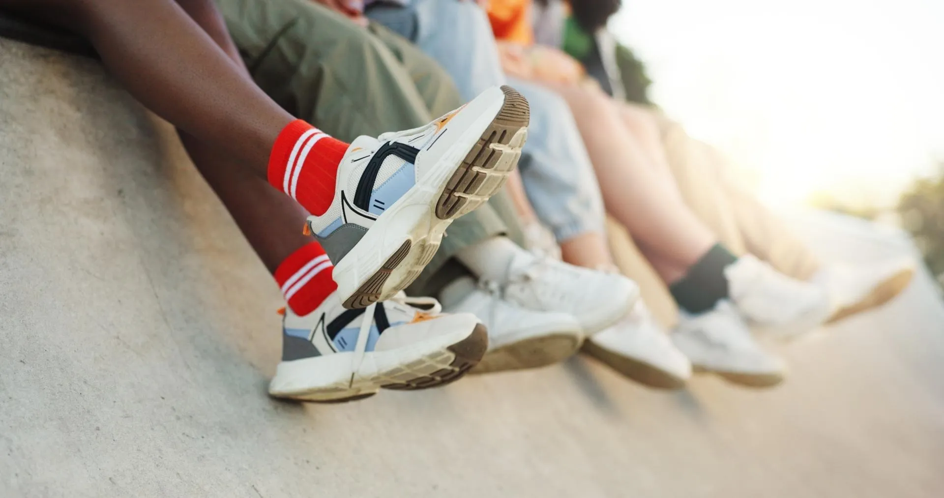 Close-up of a group of legs with sneakers.