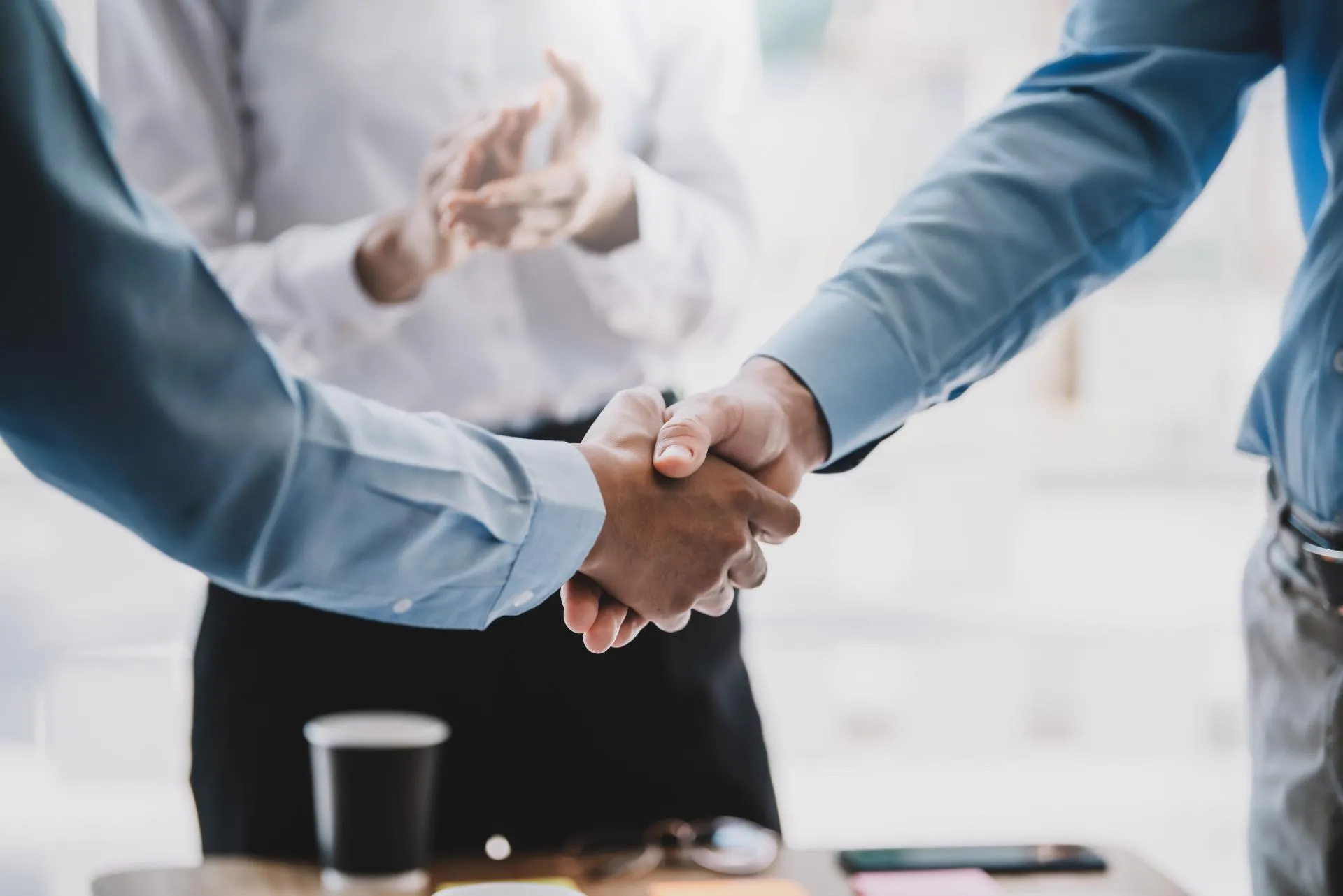 Businessmen shaking hands to formalise a strategic partnership agreement.