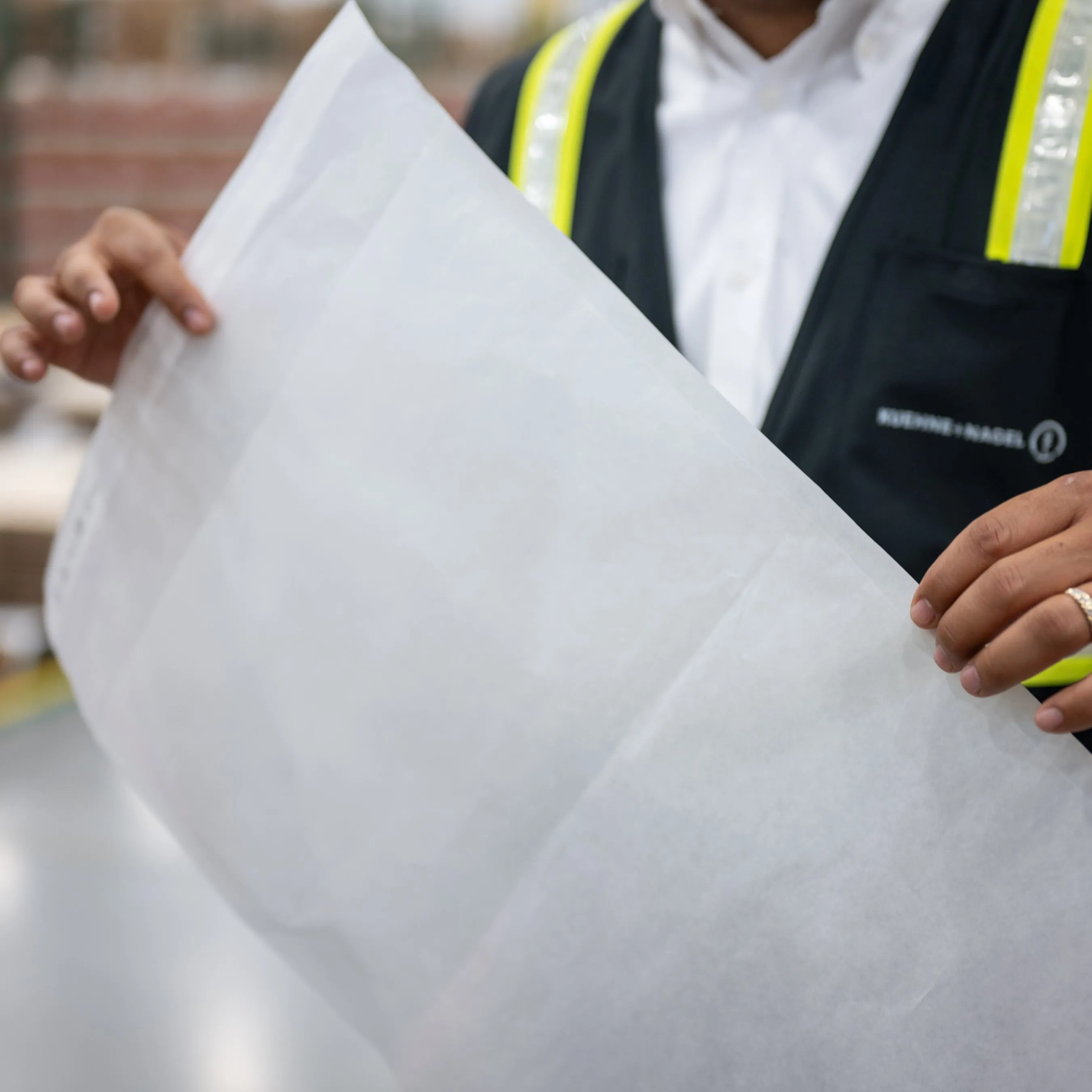Worker holding a Glassine bag