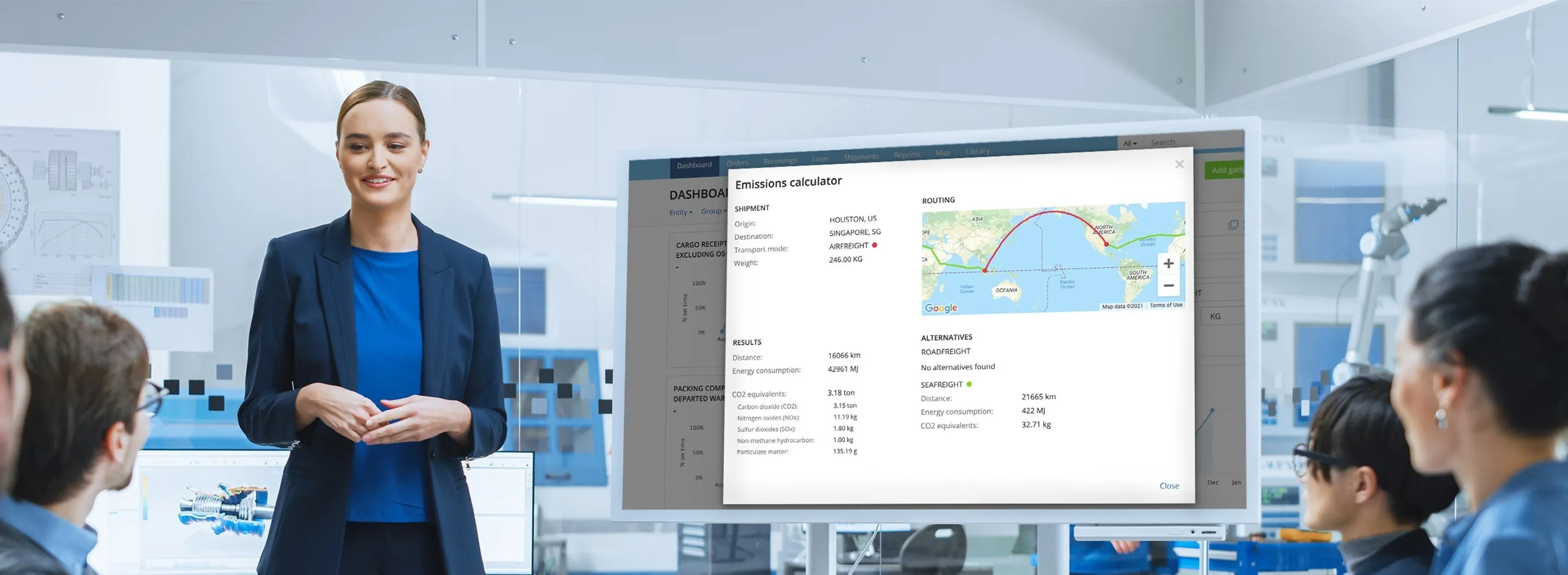 A woman stands in front of a large screen displaying the emission calculator.