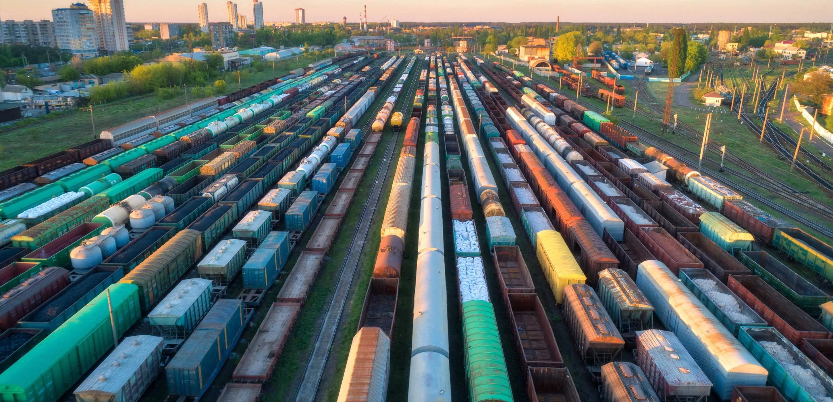 Aerial view of colorful freight trains on railway station at sunset