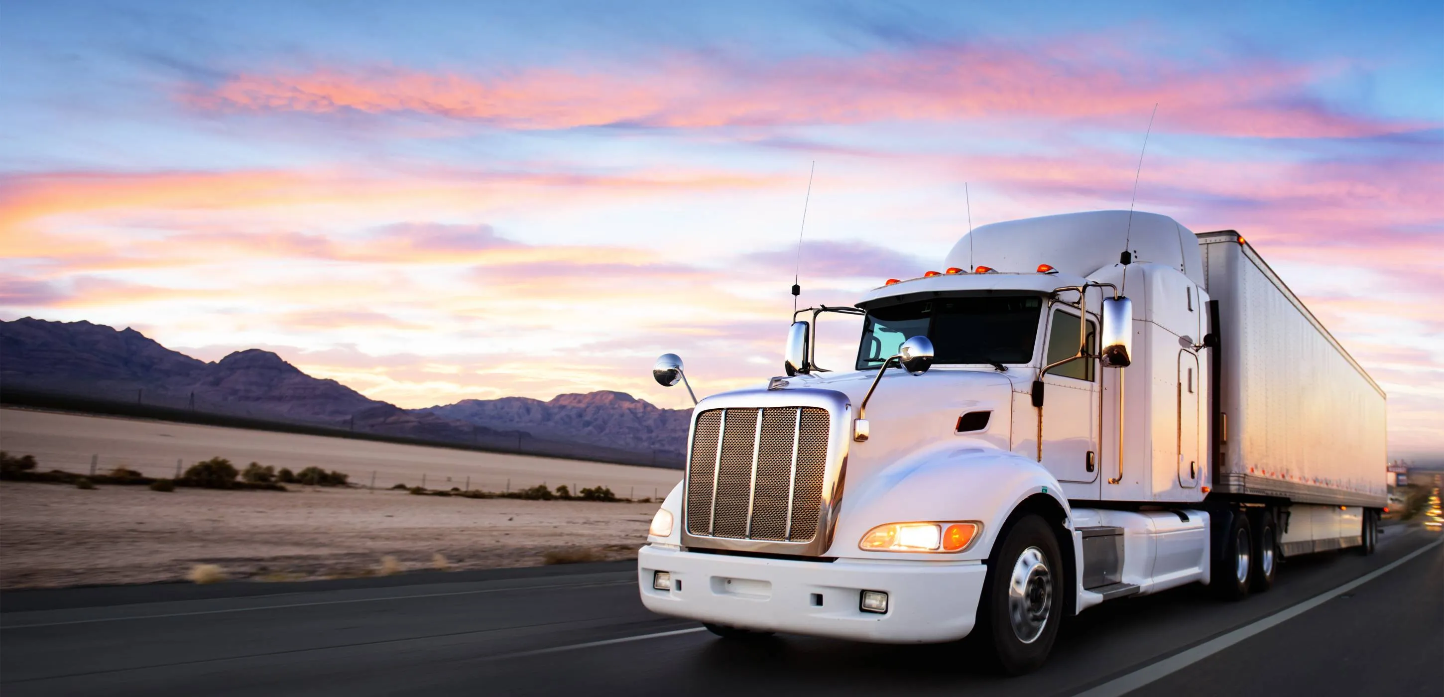 Truck and highway at sunset