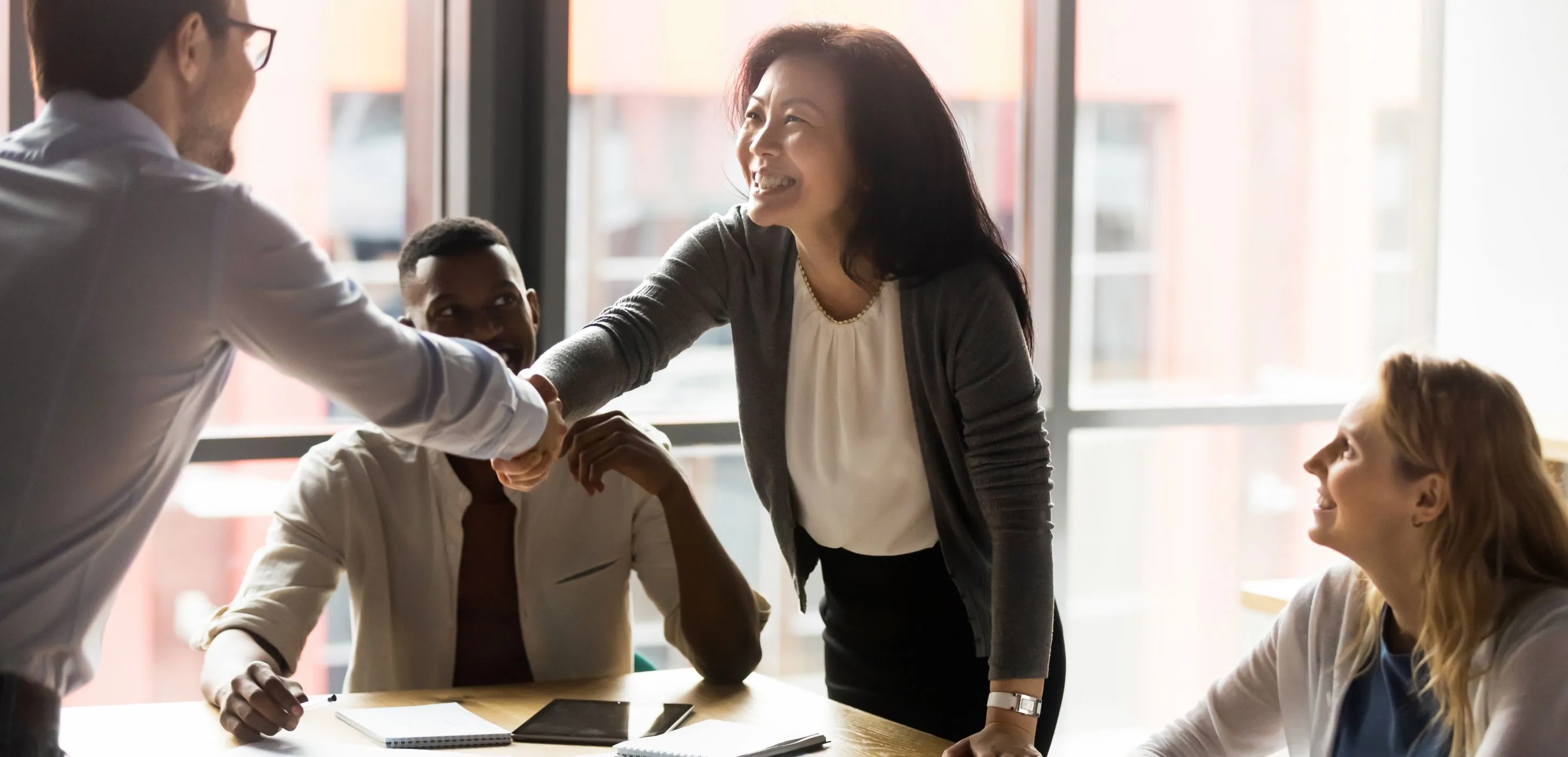 Businesswoman shake hands with client