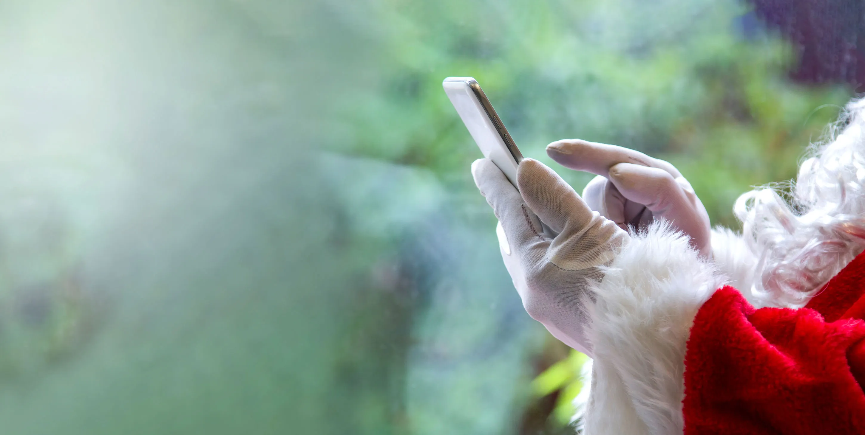 Santa Clause holding a mobile phone in his hands