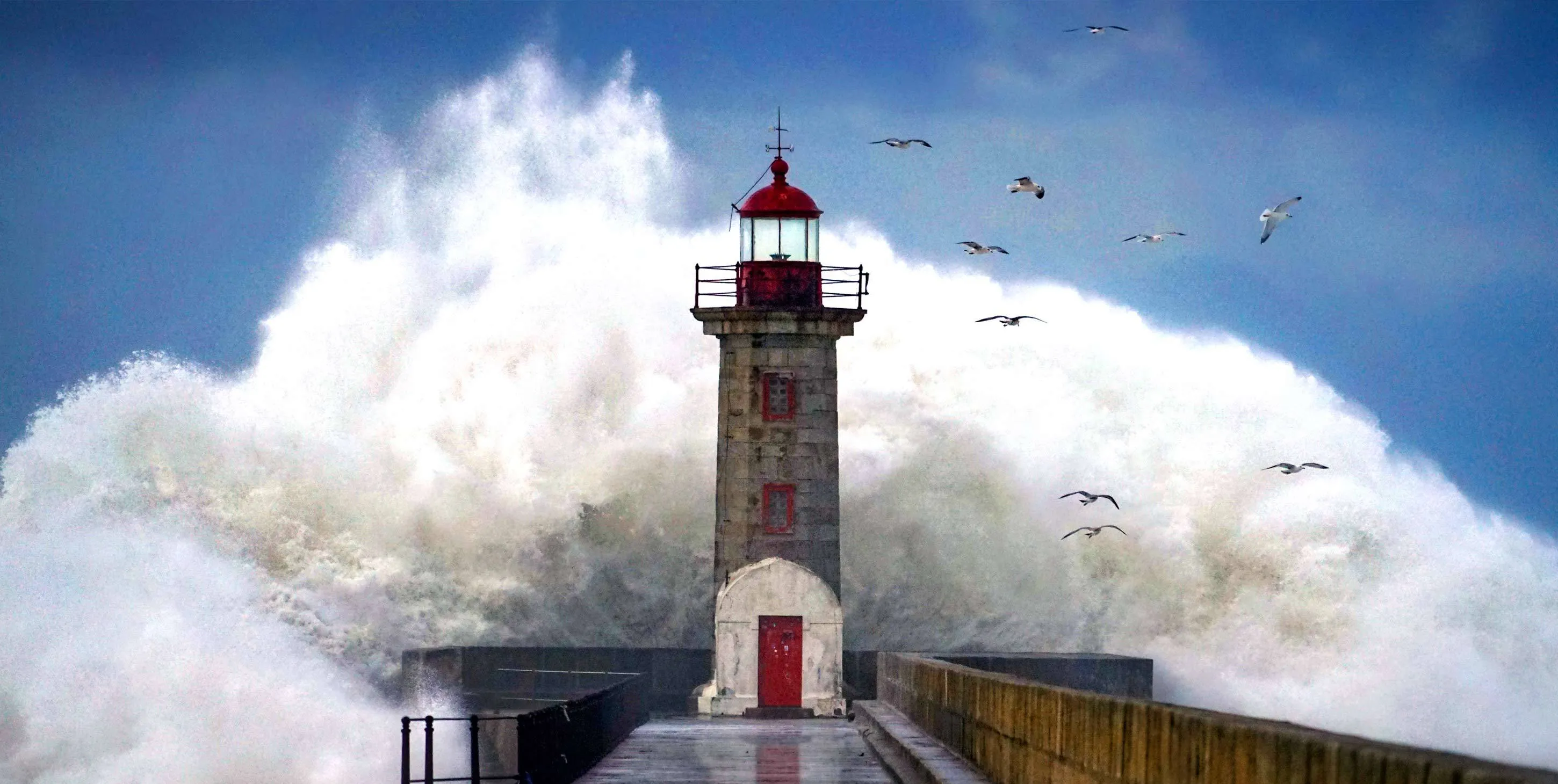 Lighthouse with seagulls and with a really big wave
