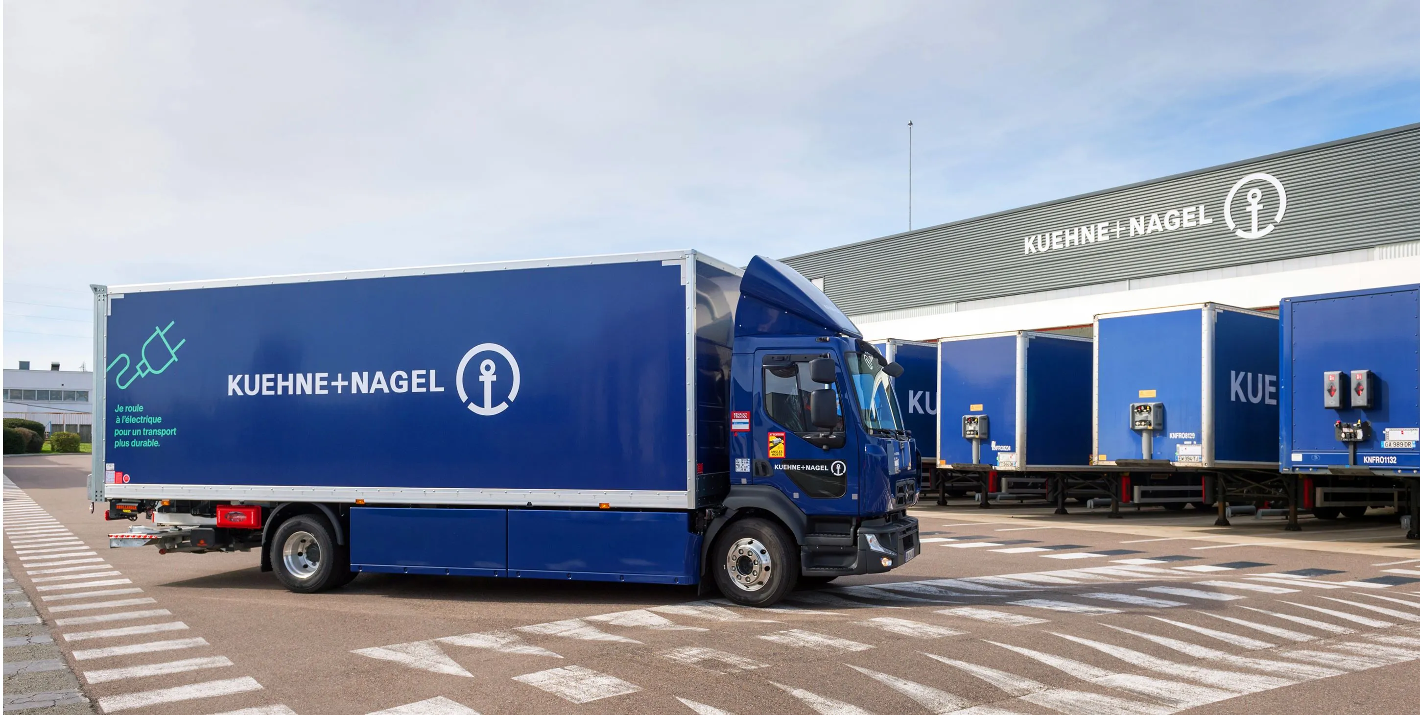 Kuehne+Nagel electric truck in front of a warehouse
