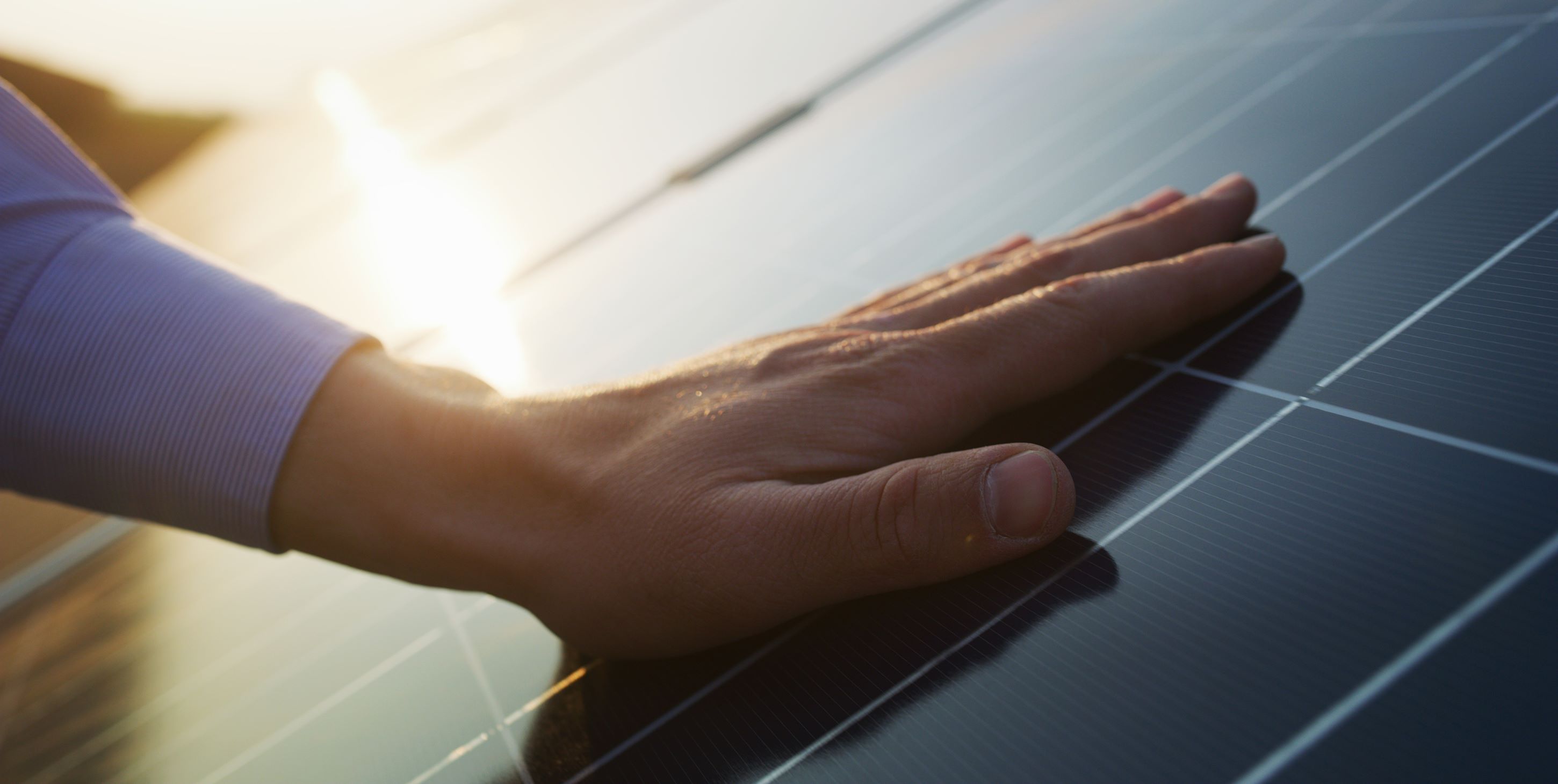 The hand on solar panel