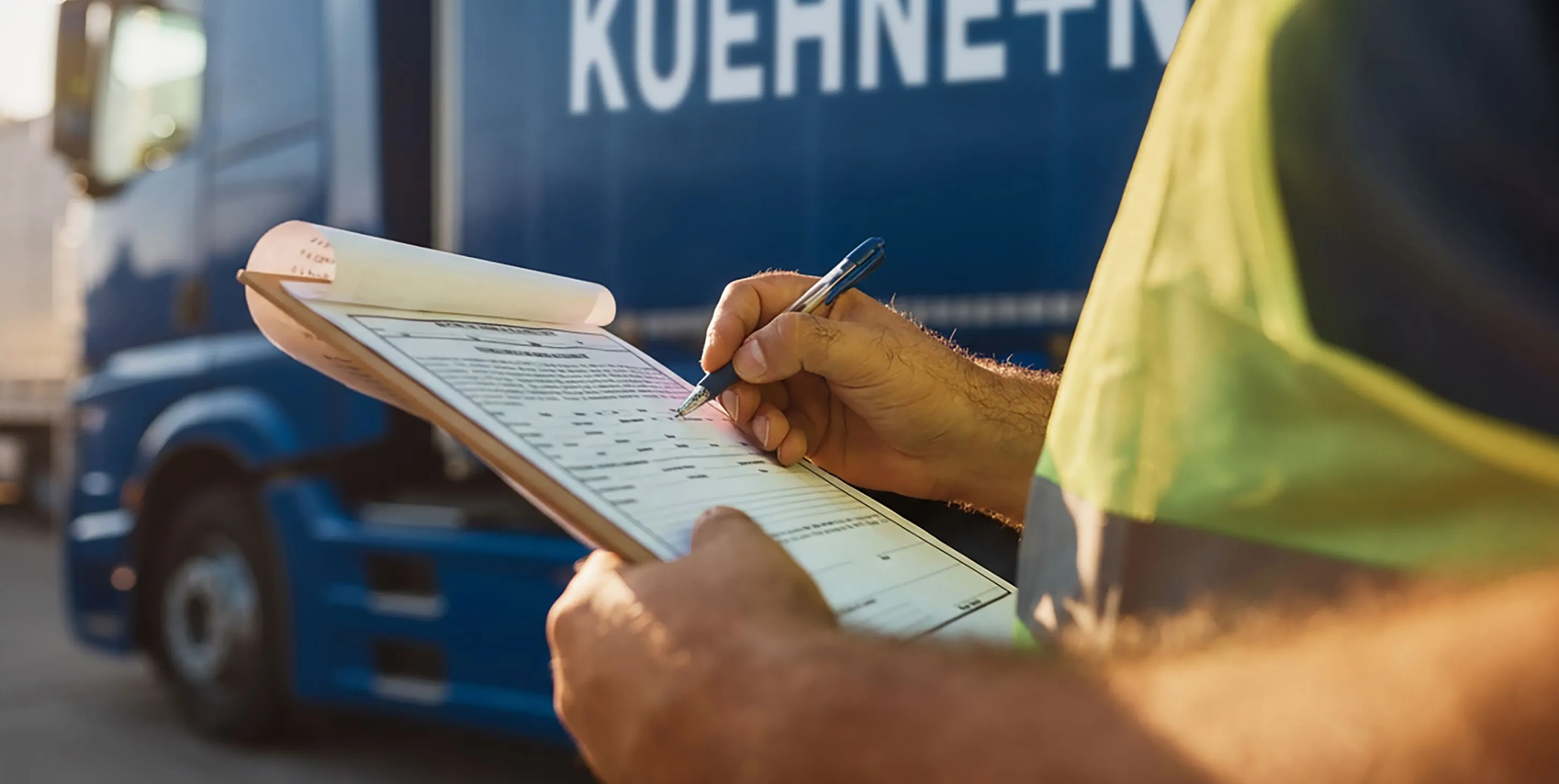 Close up of trucking dispatcher going through checklist on parking lot