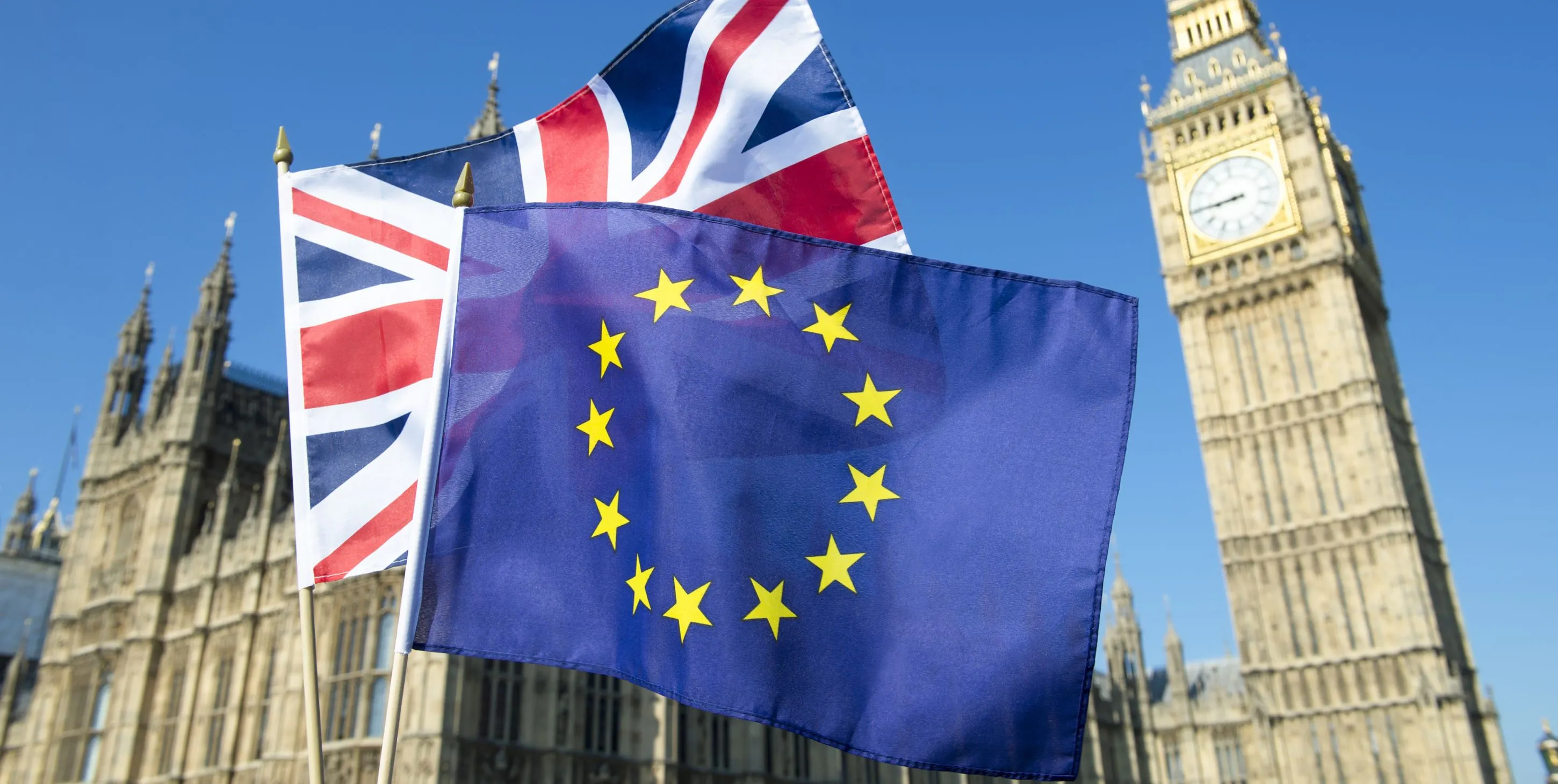 The UK and EU flags are displayed in front of Big Ben.