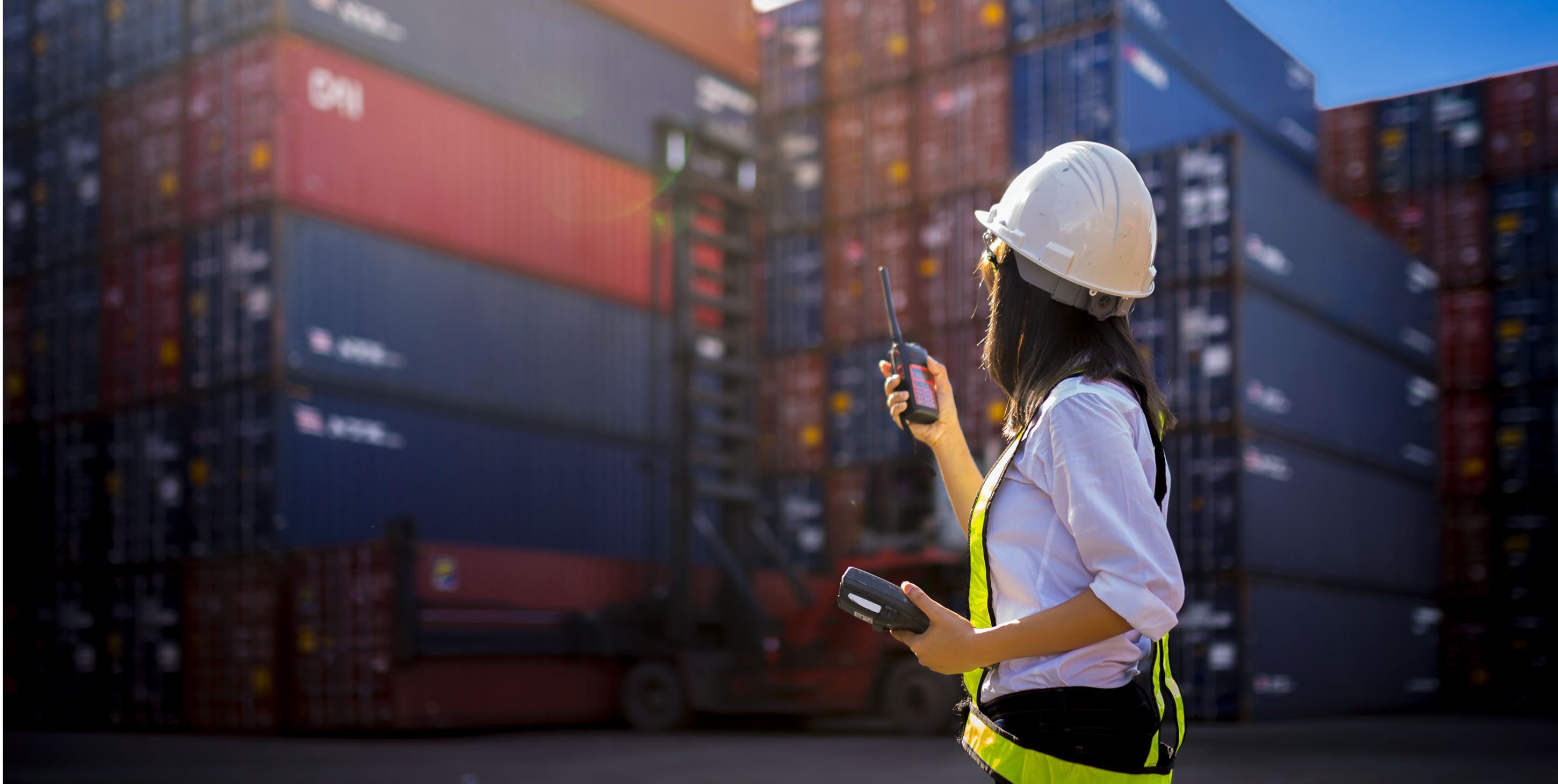 A woman in front of a container