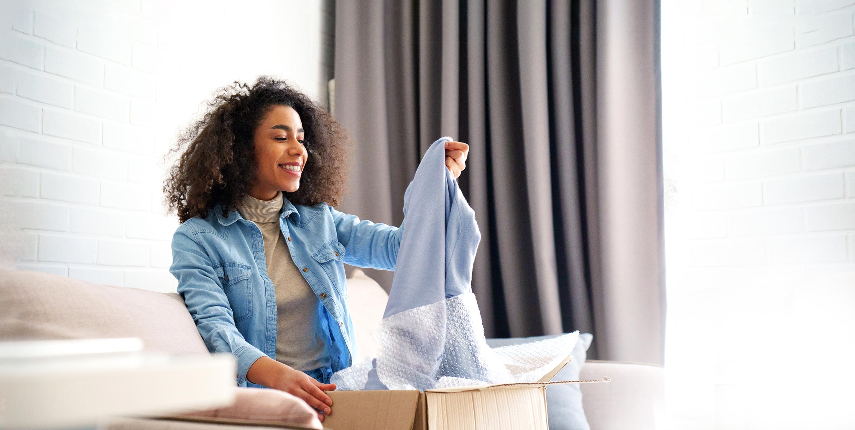 A happy woman opens a package
