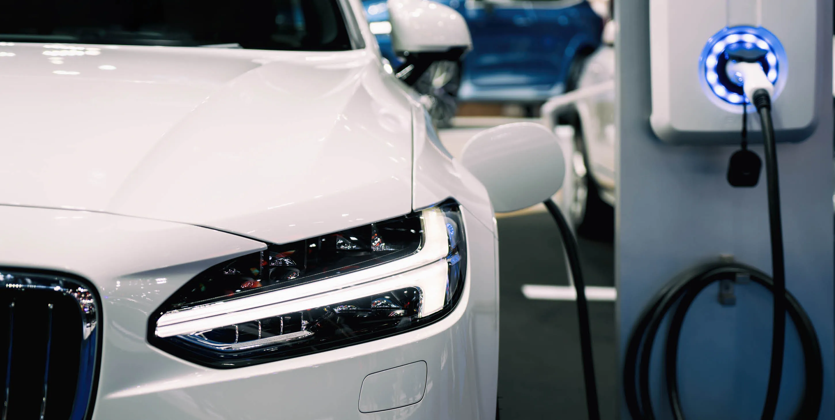 Partial front view of an electric car being charged
