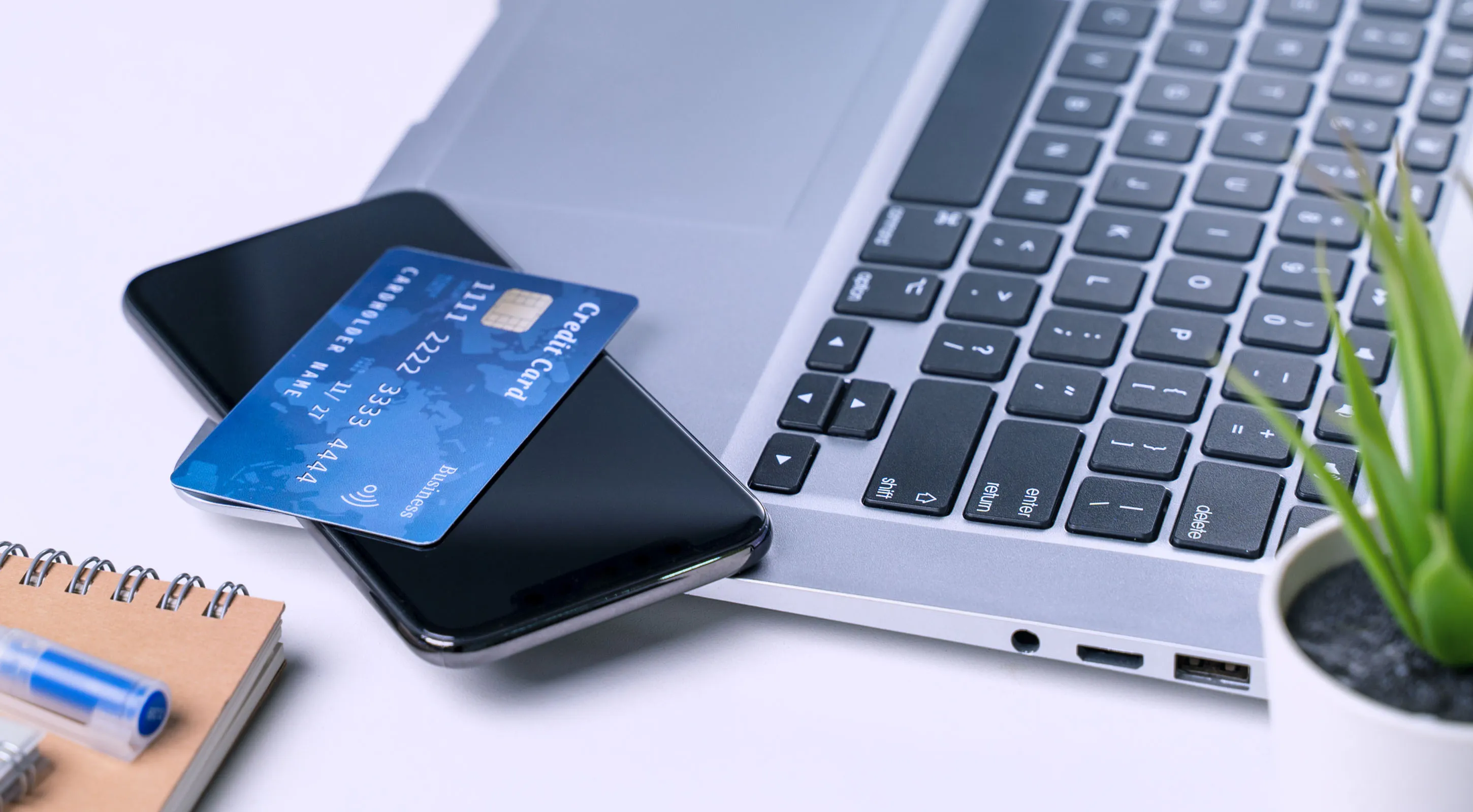 Image with a laptop, credit card and pencil