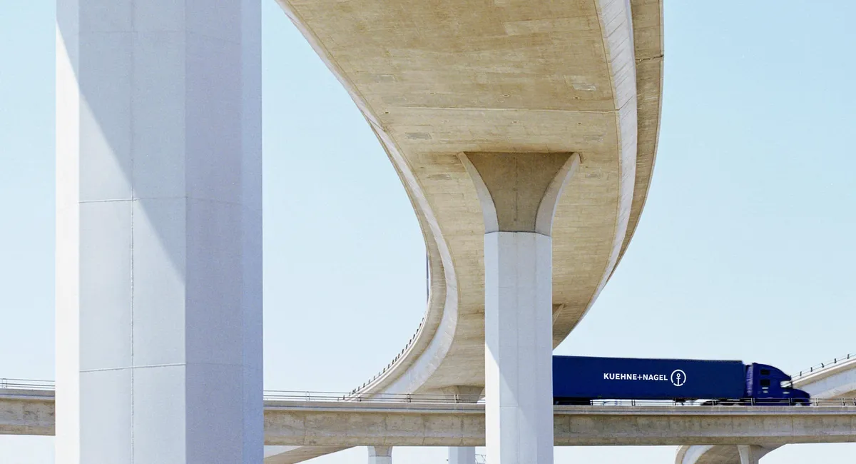 Side view of a Kuehne+Nagel truck on the bridge
