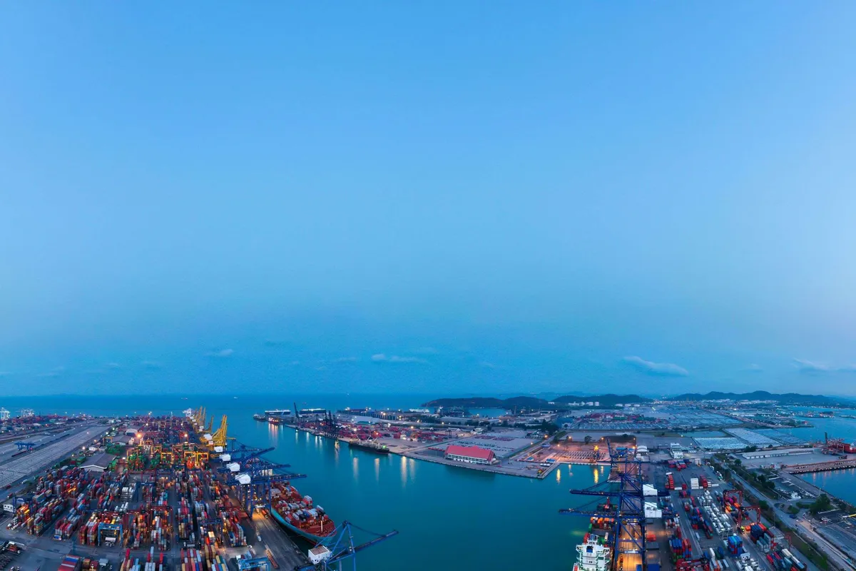 Harbour view at blue hour with containers, vessels and horizon