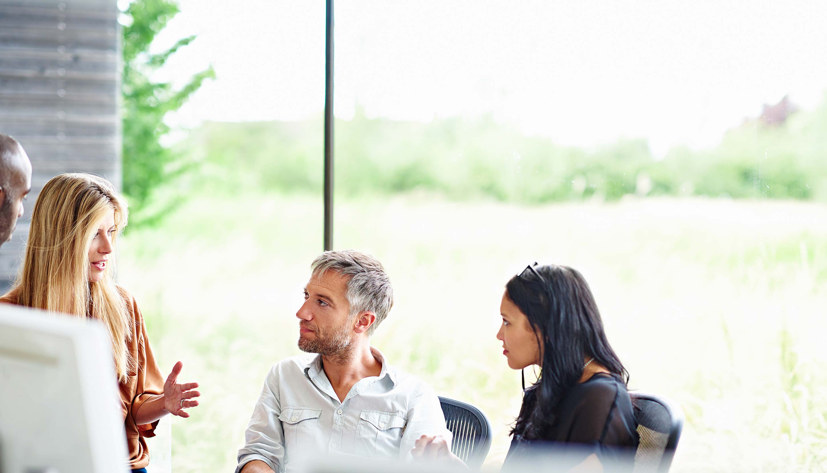Group of people in an office meeting with blurred faces