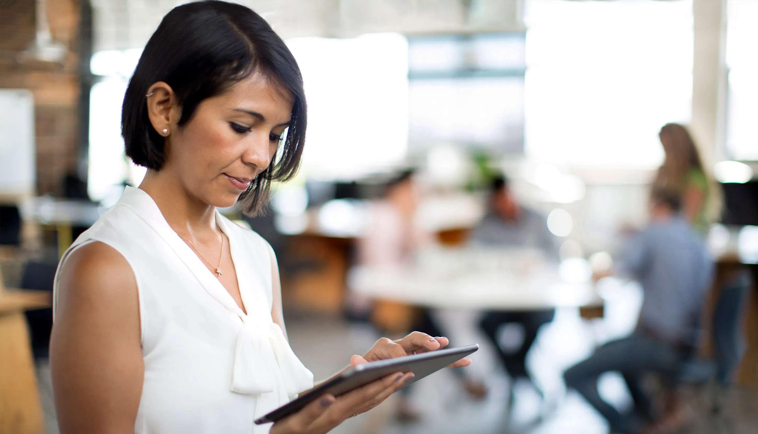 Professional using tablet in modern office