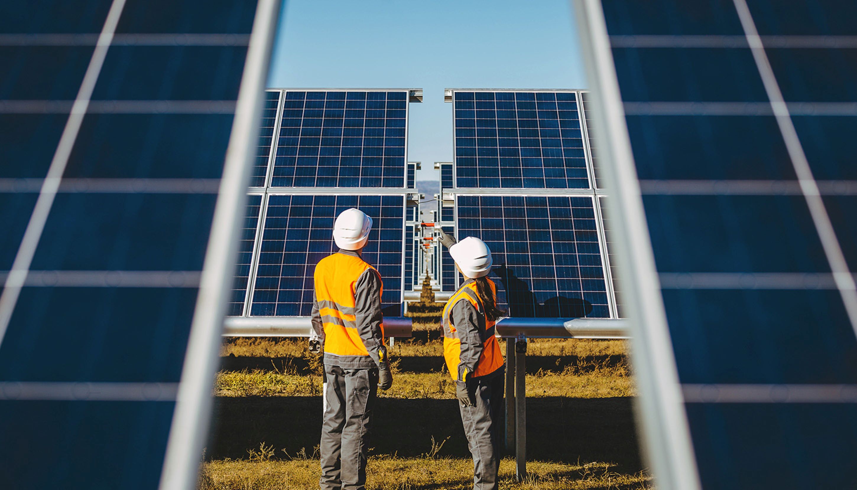 Solar power engineers infront of solar panels