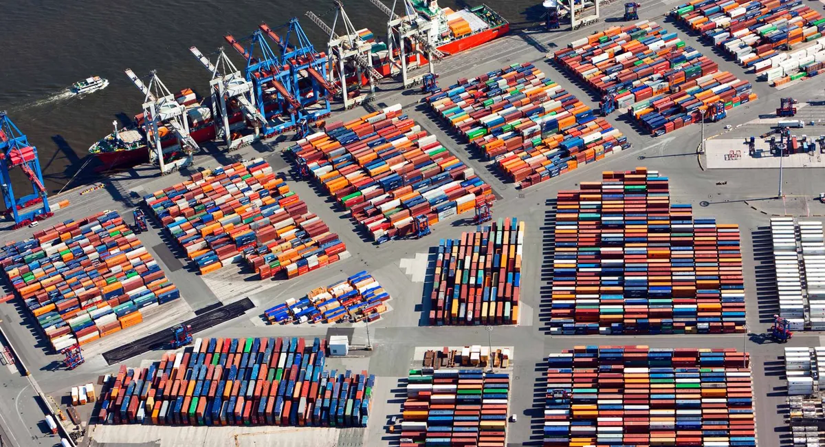 This is an aerial view of a container yard with cranes.
