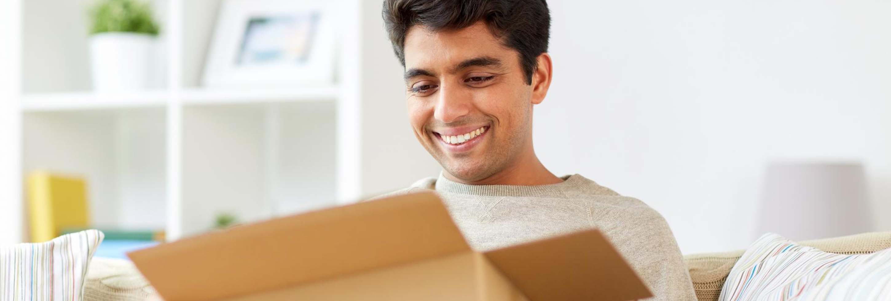 A joyful moment as someone opens a box with a smile