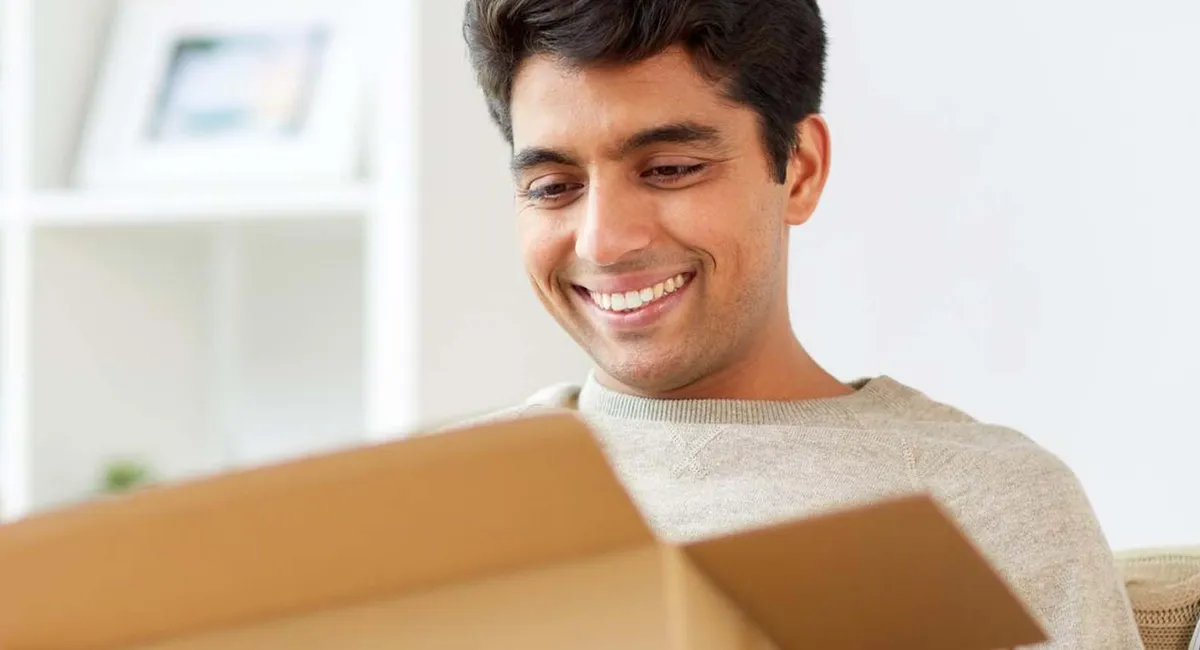 A joyful moment as someone opens a box with a smile