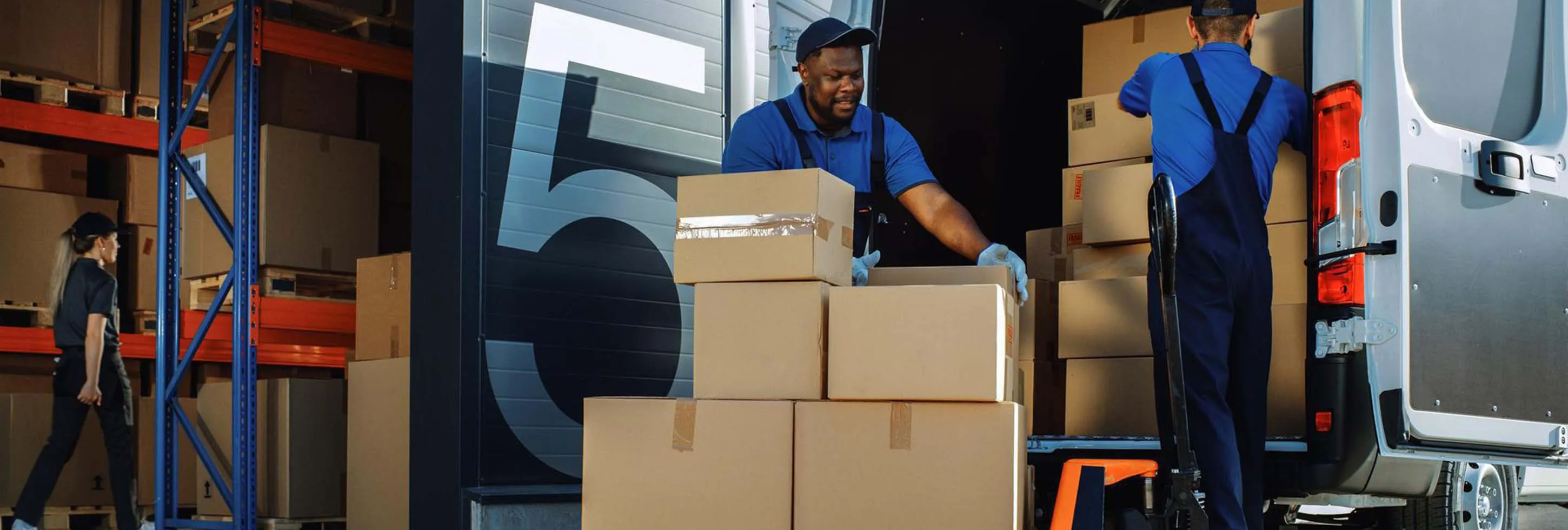 Boxes being loaded into the truck by the workers
