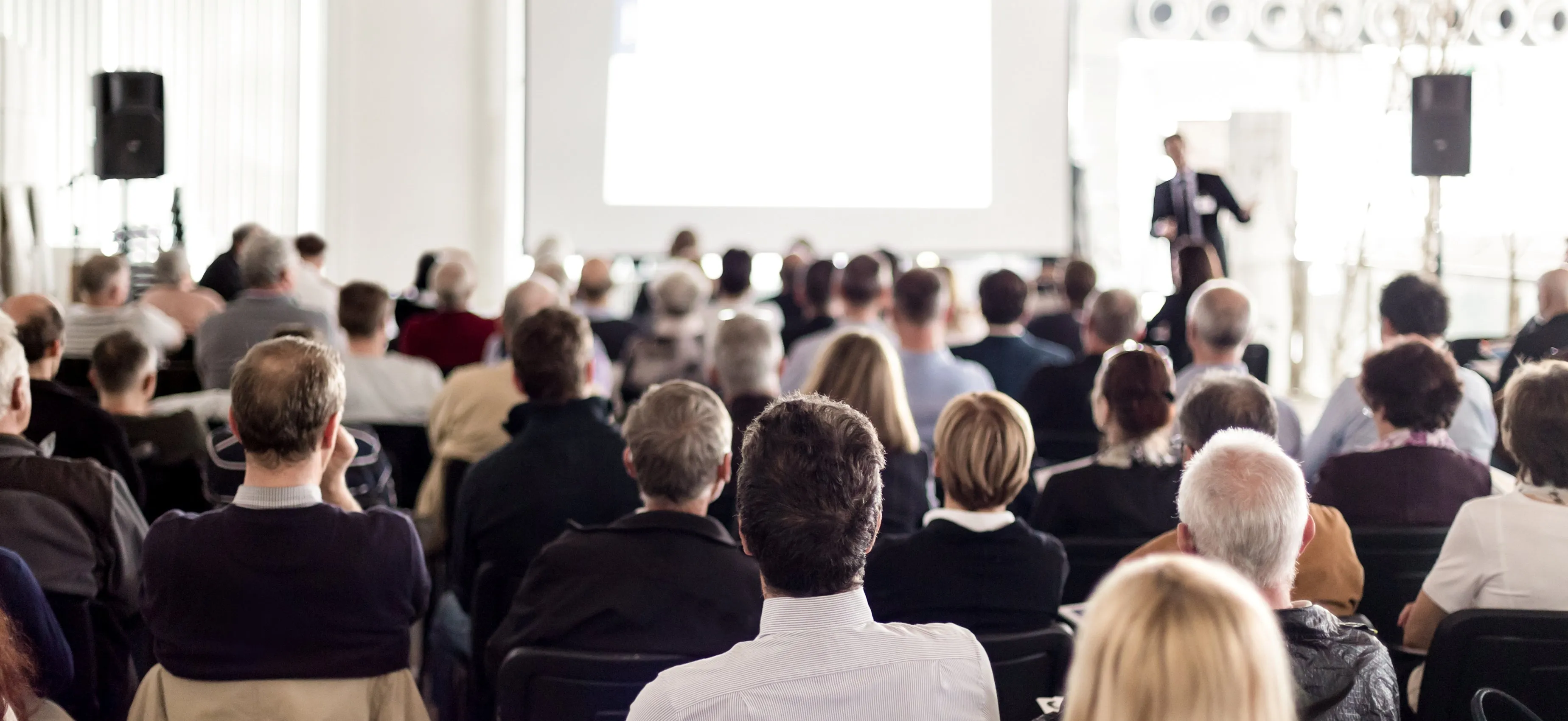 Audience in the conference hall. Business and entrepreneurship. Panoramic composition suitable for banners.