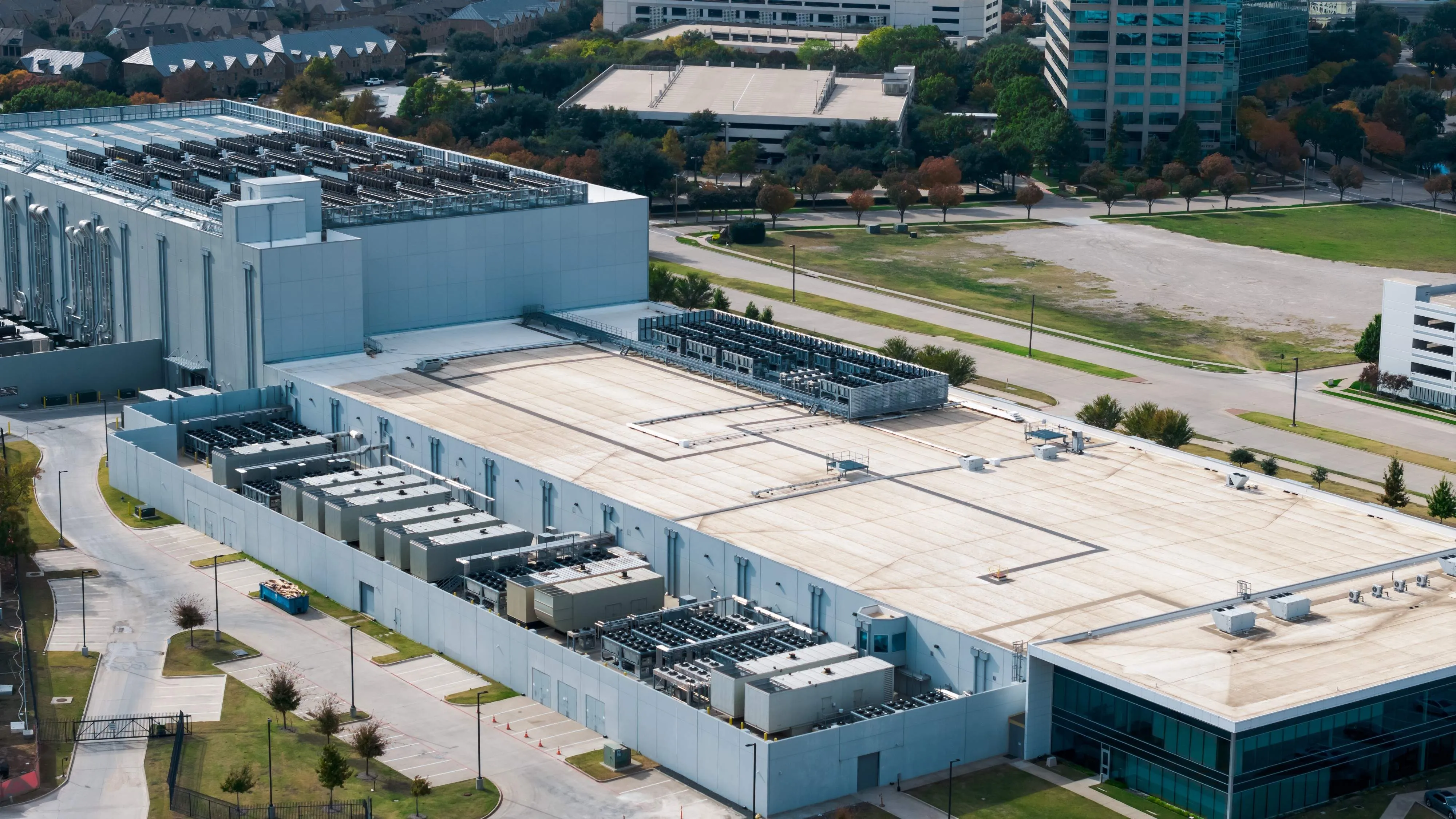Aerial view of a large data centre facility featuring cooling systems, electrical infrastructure, and technical equipment supporting cloud computing operations.