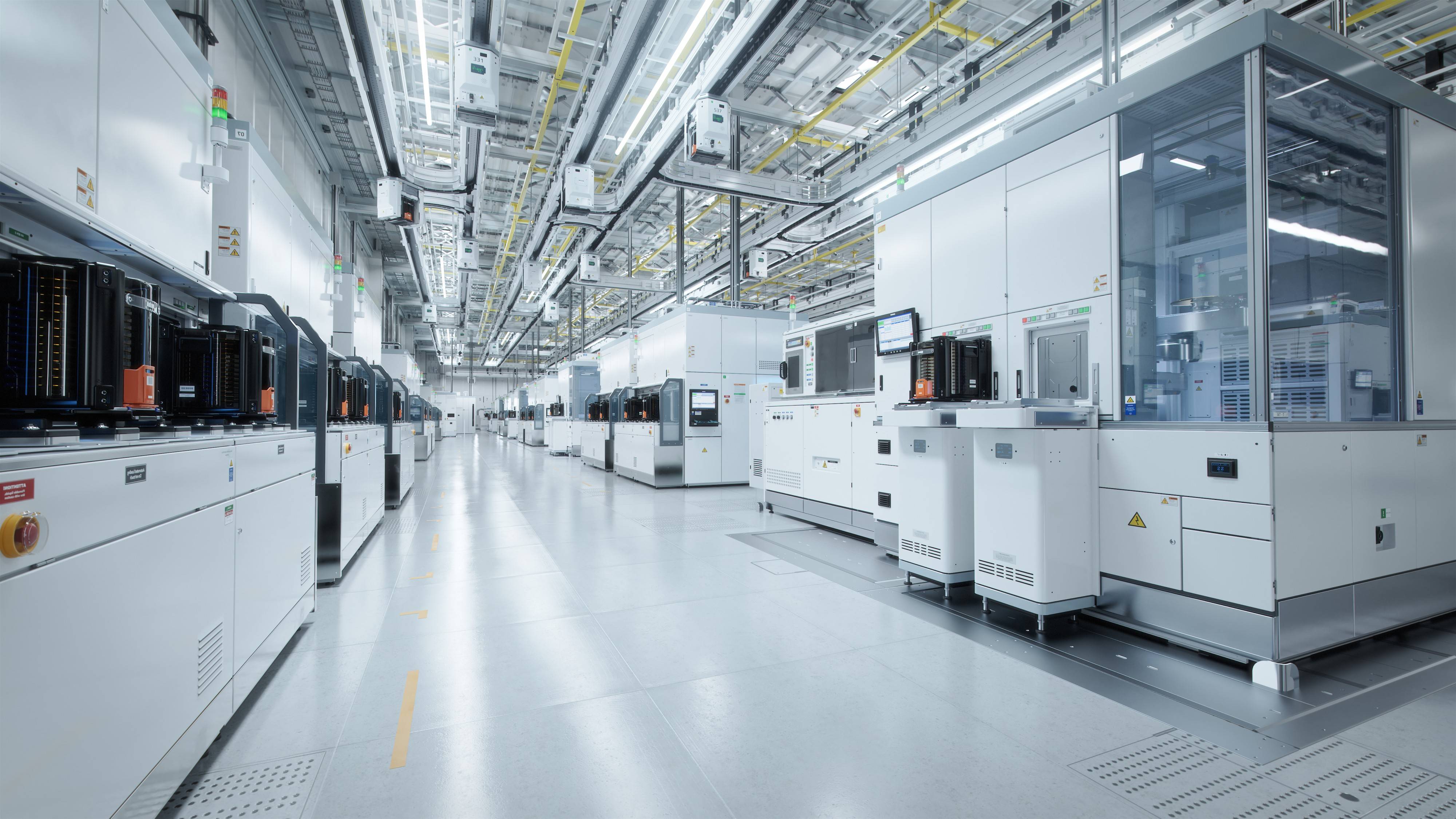 Semiconductor fab cleanroom featuring advanced manufacturing equipment and automated production tools used in semiconductor fabrication.