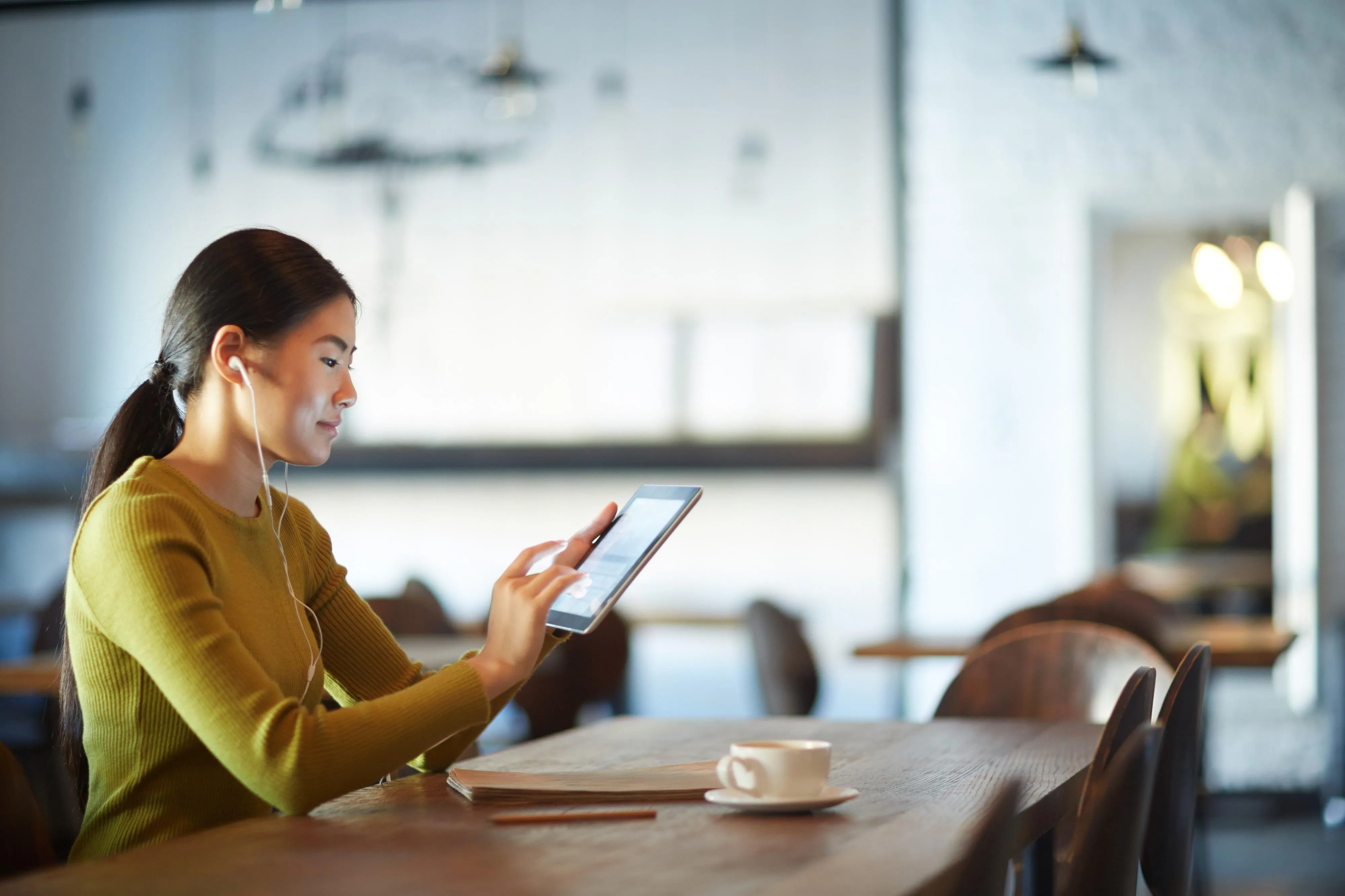 Asian lady holding tablet