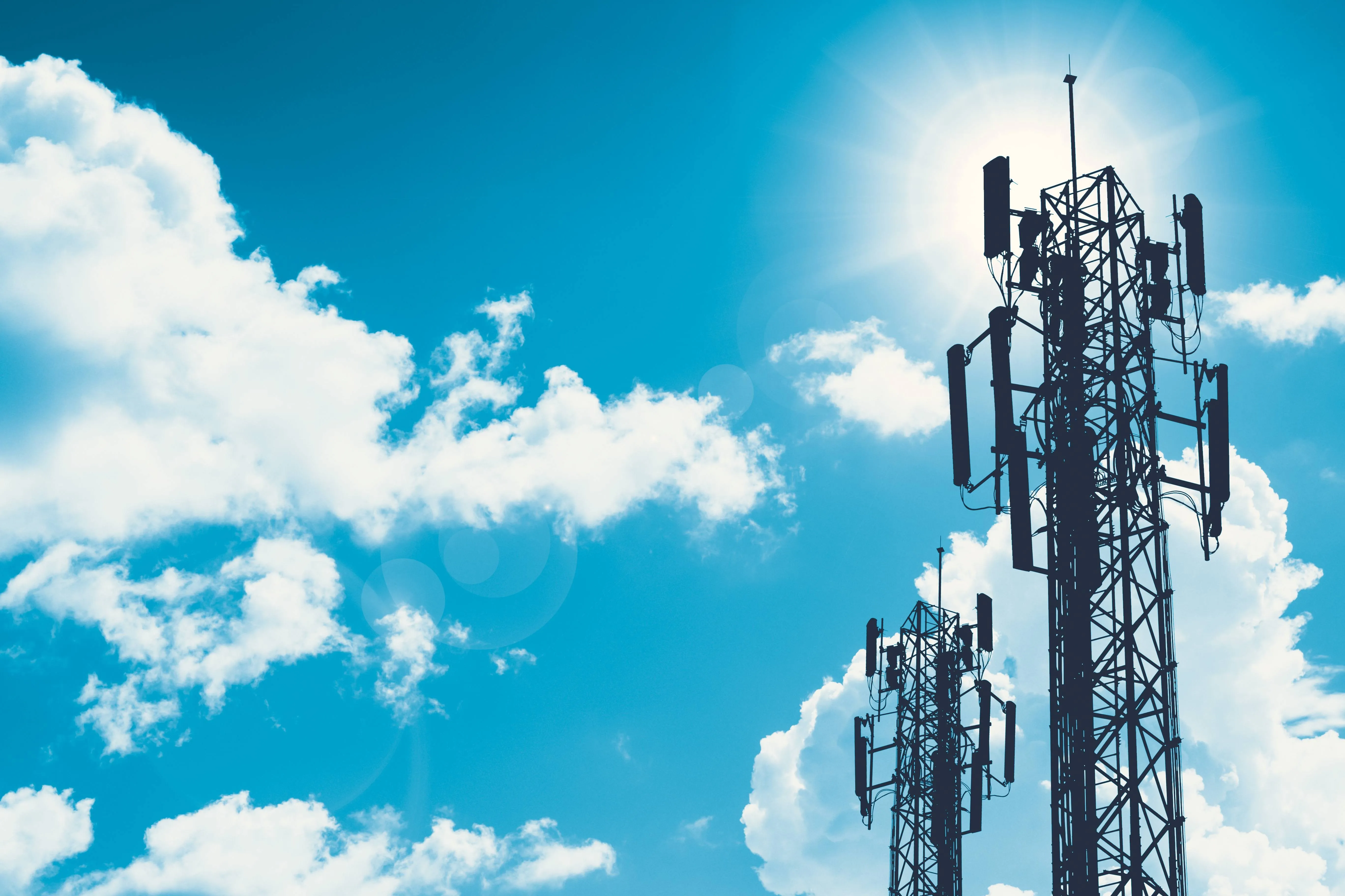 Communication tower or 3G 4G network telephone cellsite silhouette on blue sky and space for text