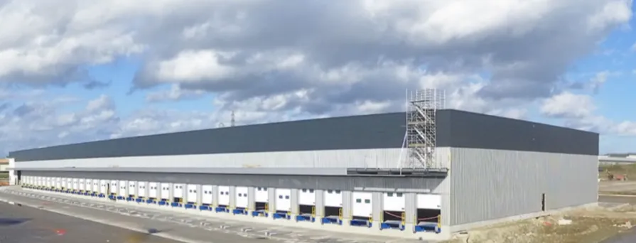 New location showing in the picture with the great blue sky and the distribution centre