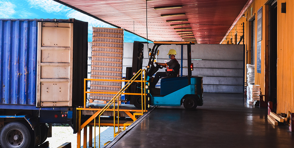 Worker efficiently loading goods into a delivery truck