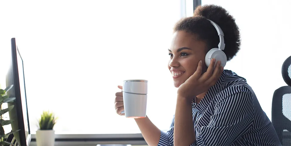 Girl drinking coffee while talking on her laptop