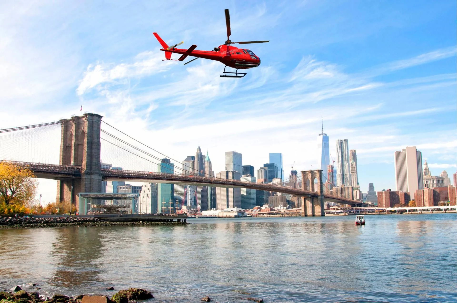 Helicopter flying over New York City skyscrapers and Brooklyn Bridge, USA