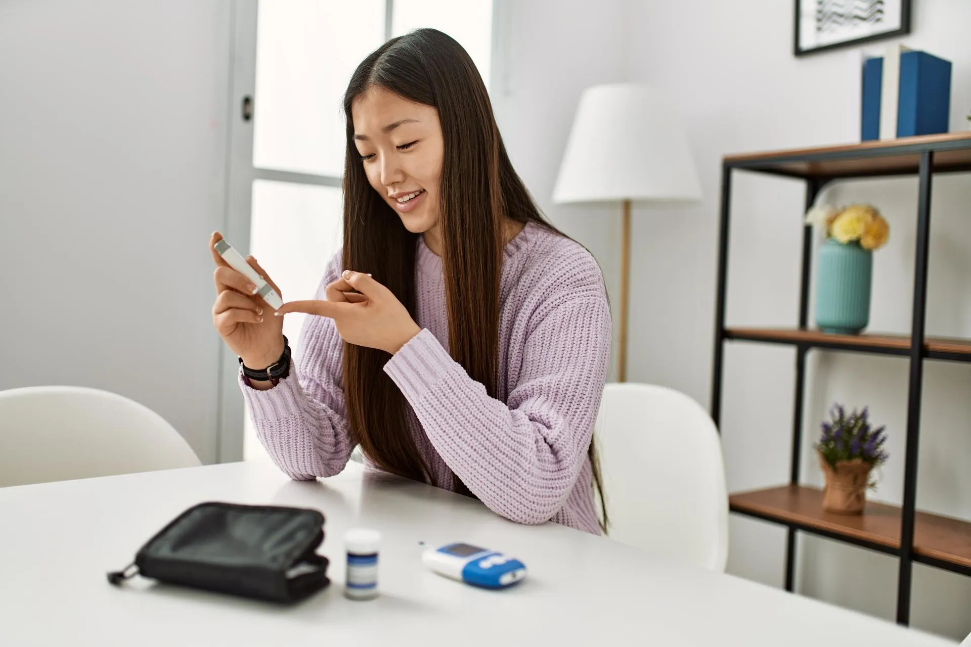 Chinese-girl-using-glucometre-to-track-blood-sugar-level-at-home