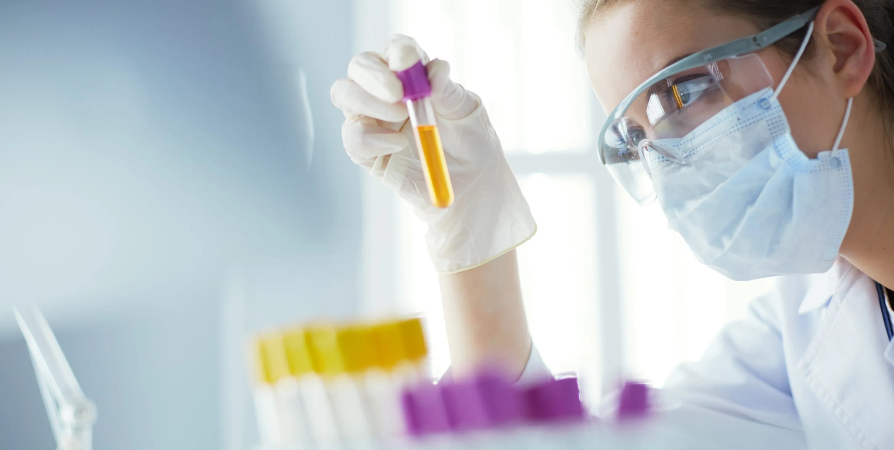 Woman holding and inspecting a sample pipette