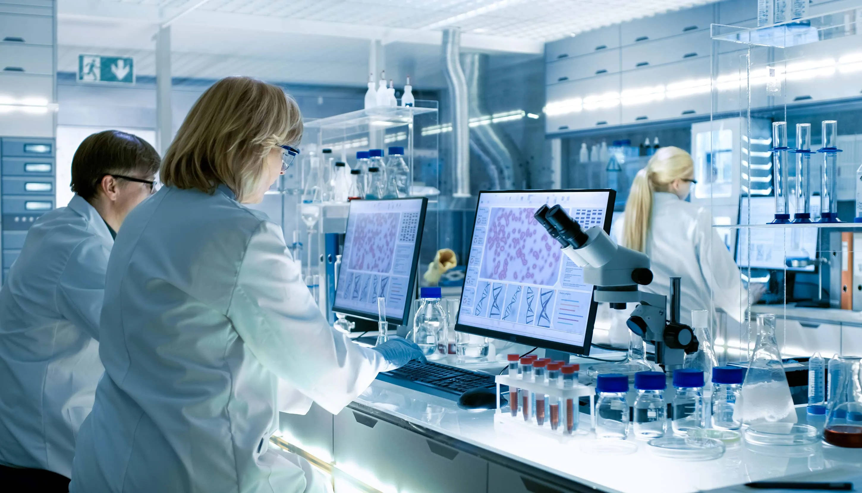 3 scientists testing in a big laboratory