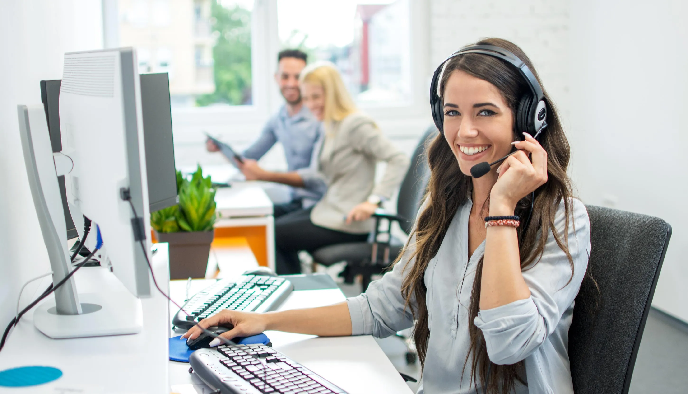 Woman talking on a headset in a call centre